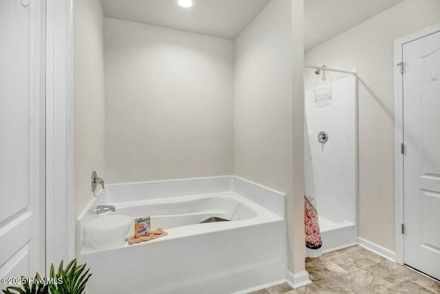 full bathroom featuring walk in shower and a bath