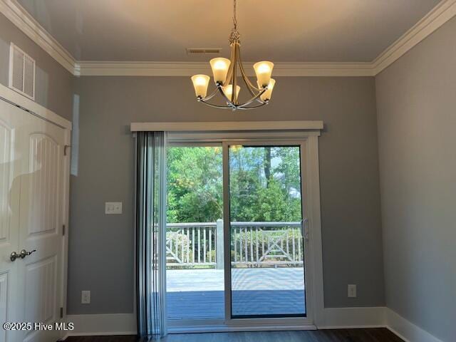 entryway with crown molding, baseboards, and wood finished floors