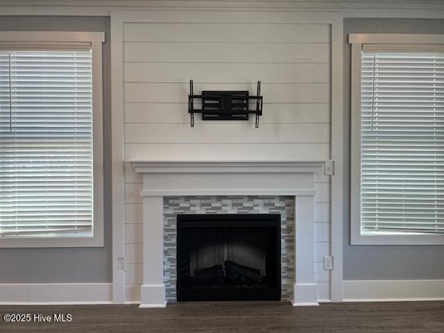 room details with wood finished floors, a fireplace, and baseboards