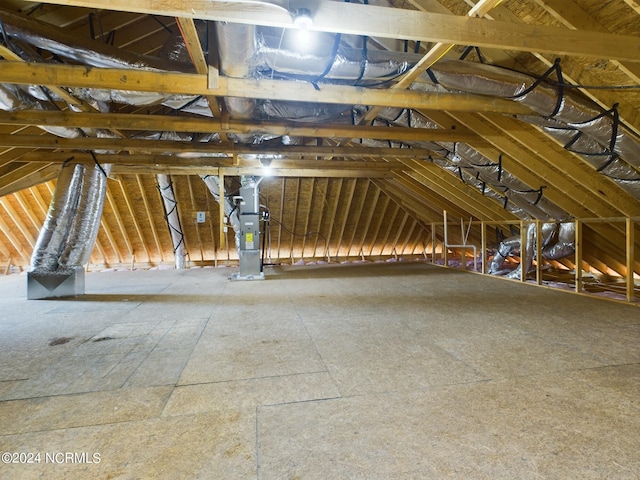 unfinished attic featuring heating unit