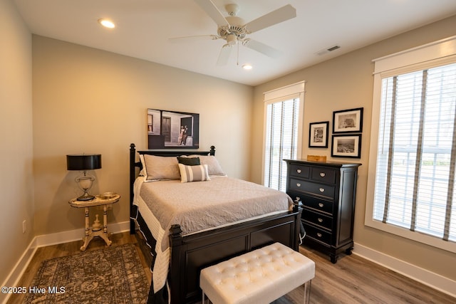 bedroom featuring multiple windows, visible vents, and wood finished floors