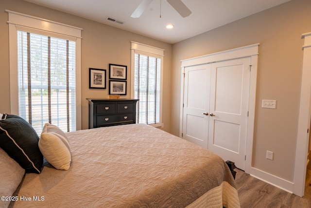 bedroom featuring multiple windows, visible vents, and baseboards