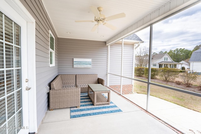 sunroom / solarium featuring a ceiling fan