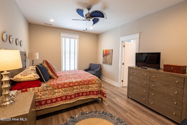 bedroom featuring recessed lighting, wood finished floors, a ceiling fan, visible vents, and baseboards