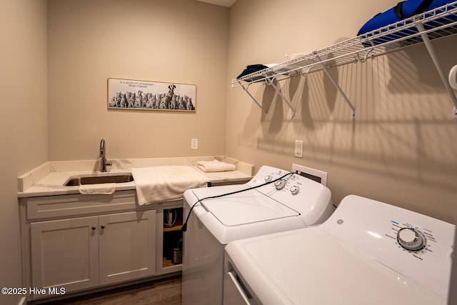 laundry room with separate washer and dryer, cabinet space, a sink, and dark wood finished floors