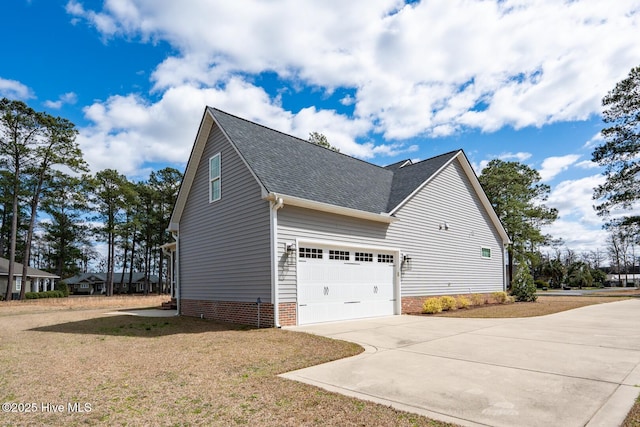 view of home's exterior featuring a shingled roof and concrete driveway