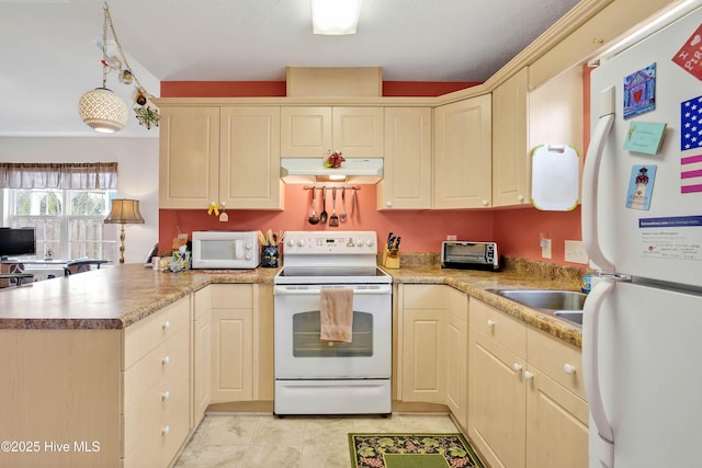 kitchen with a toaster, a peninsula, white appliances, under cabinet range hood, and hanging light fixtures