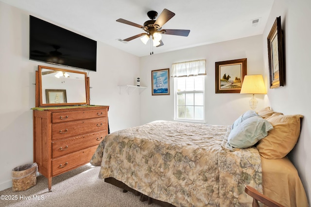 carpeted bedroom featuring visible vents and a ceiling fan
