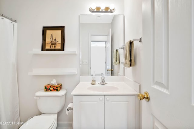 full bathroom with toilet and vanity