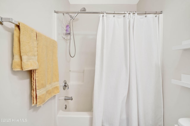 bathroom featuring toilet and shower / bath combo with shower curtain