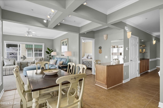 dining room featuring beam ceiling, crown molding, and light tile patterned floors