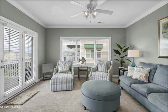 living room featuring ornamental molding, a healthy amount of sunlight, visible vents, and carpet flooring