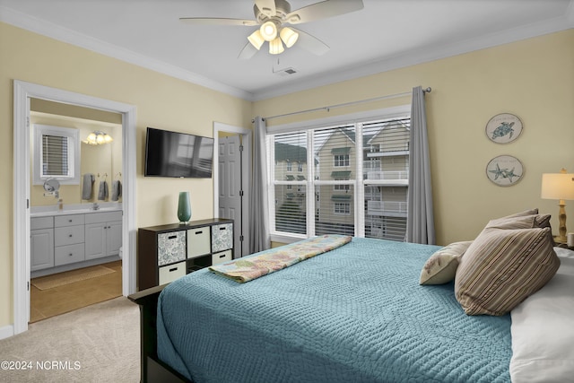 bedroom featuring a ceiling fan, light carpet, crown molding, and ensuite bath