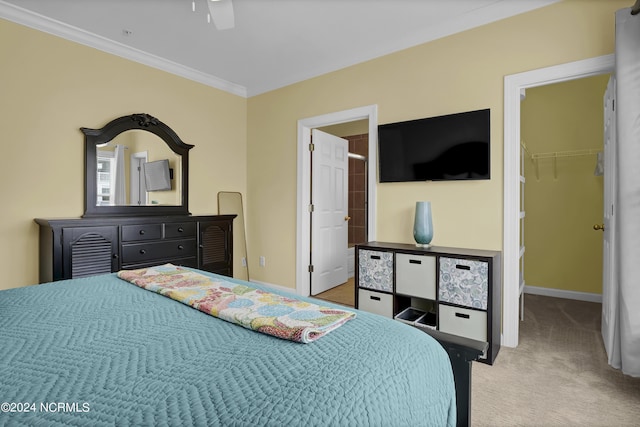 bedroom featuring carpet floors, baseboards, a spacious closet, and ornamental molding