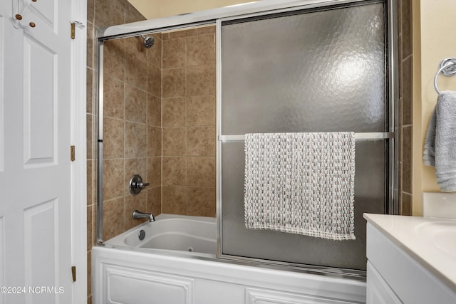 bathroom featuring shower / bath combination with glass door and vanity