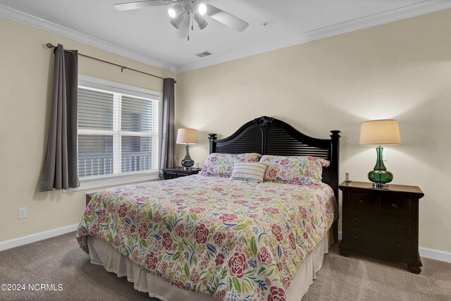 carpeted bedroom with ceiling fan, ornamental molding, visible vents, and baseboards