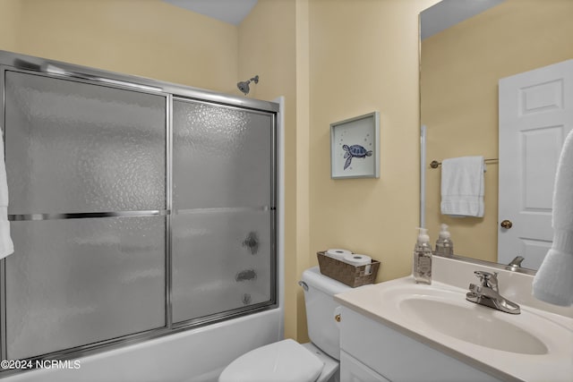 bathroom featuring shower / bath combination with glass door, vanity, and toilet