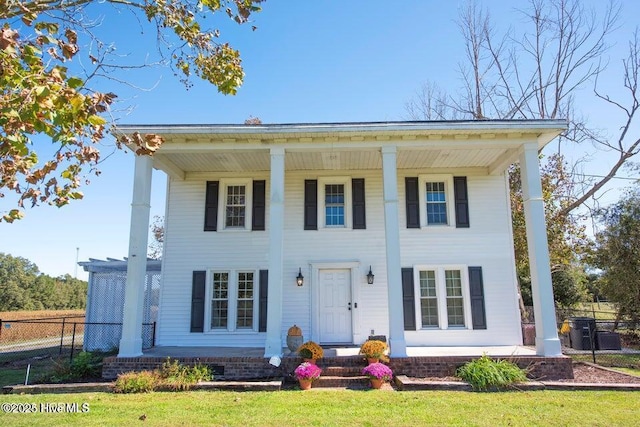 view of front of home featuring covered porch and fence