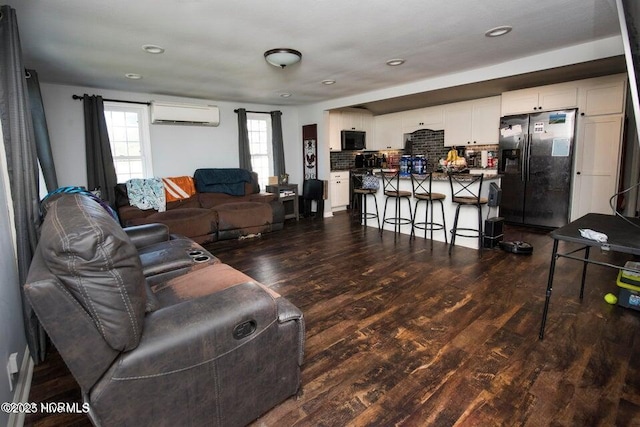 living area with dark wood-style flooring, a wall mounted air conditioner, and recessed lighting