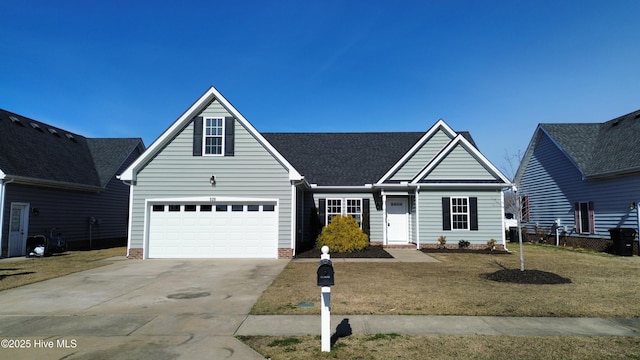 view of front of property with an attached garage, concrete driveway, and a front yard