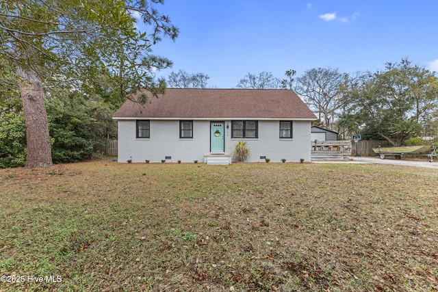 single story home with a front yard, fence, roof with shingles, crawl space, and brick siding