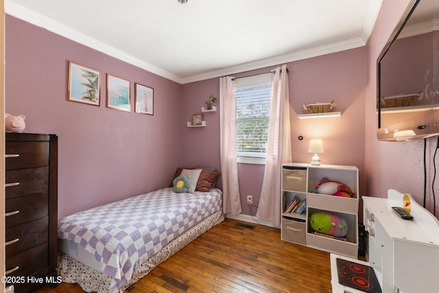 bedroom featuring visible vents, crown molding, and hardwood / wood-style flooring