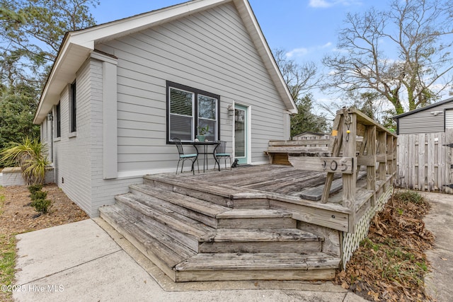 wooden terrace featuring fence