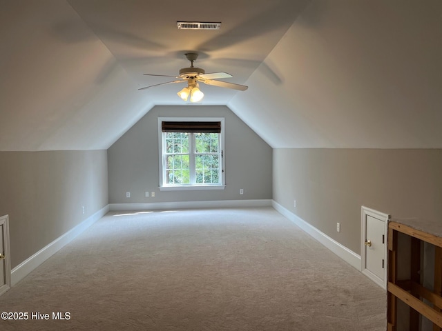 bonus room featuring a ceiling fan, carpet, visible vents, baseboards, and vaulted ceiling