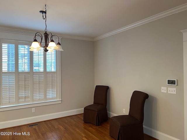 sitting room featuring visible vents, ornamental molding, wood finished floors, baseboards, and a chandelier