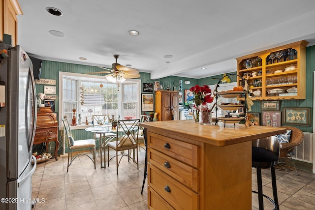 kitchen featuring butcher block countertops, a kitchen bar, recessed lighting, freestanding refrigerator, and a ceiling fan