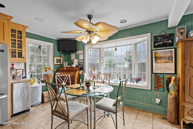 dining space featuring ceiling fan, ornamental molding, and light tile patterned floors