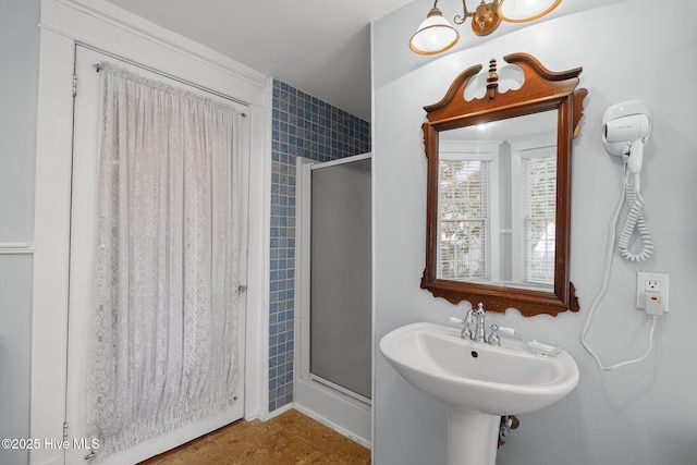 bathroom featuring tile patterned flooring and a shower stall