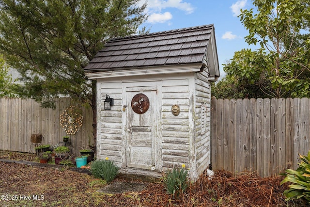 view of shed with a fenced backyard