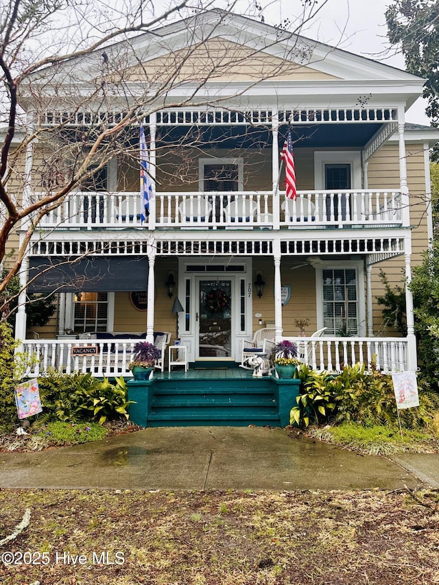 view of front of house featuring a porch and a balcony