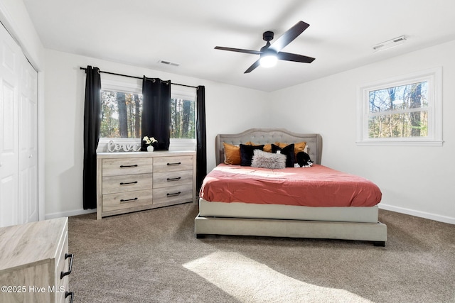 bedroom featuring carpet floors, visible vents, baseboards, and a ceiling fan