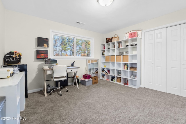 office space featuring carpet floors, baseboards, and visible vents