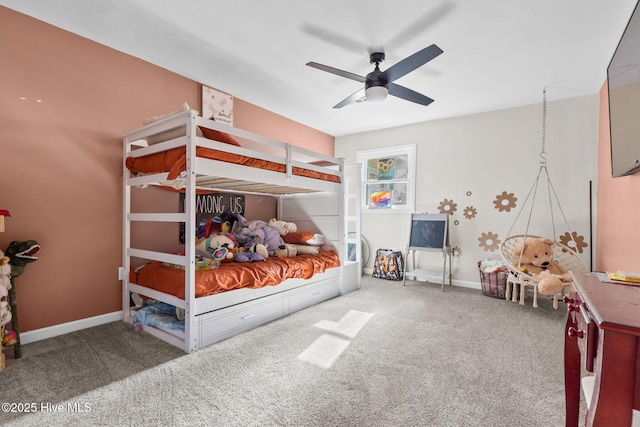 carpeted bedroom featuring a ceiling fan and baseboards