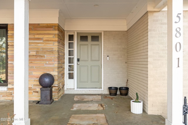 entrance to property featuring brick siding