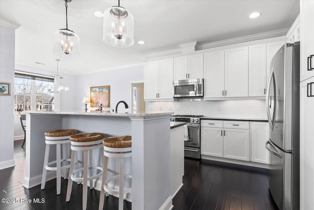 kitchen with tasteful backsplash, dark wood-type flooring, an inviting chandelier, stainless steel appliances, and white cabinetry