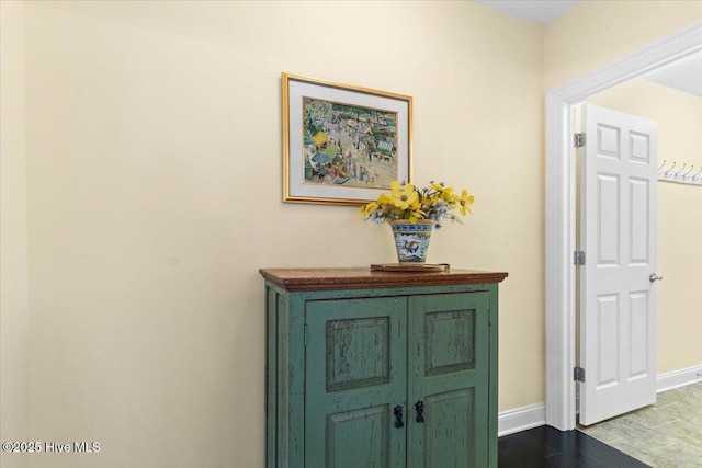 interior space with baseboards and wood finished floors