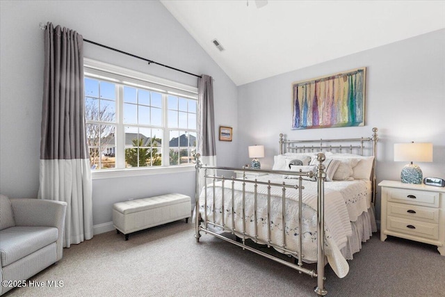 carpeted bedroom featuring lofted ceiling and visible vents