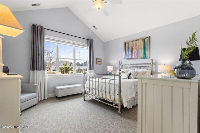 bedroom with a ceiling fan, visible vents, vaulted ceiling, and carpet flooring