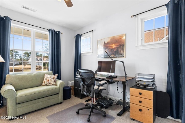 carpeted office featuring ceiling fan, visible vents, and baseboards