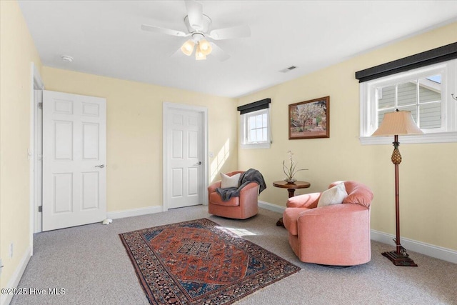 living area featuring carpet, visible vents, and baseboards