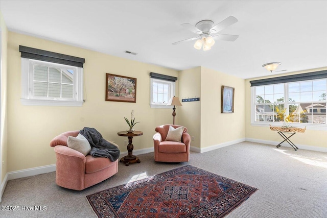 sitting room with carpet floors, baseboards, and visible vents