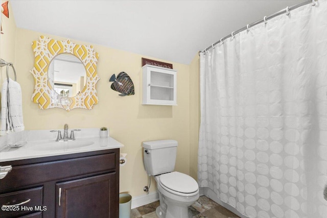 bathroom with a shower with curtain, vanity, toilet, and baseboards