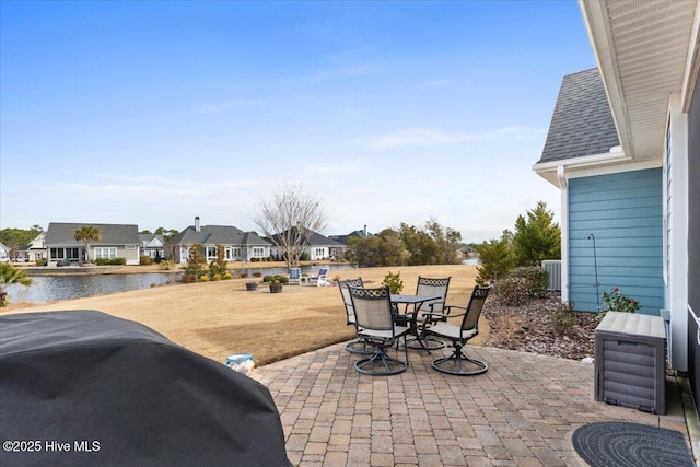 view of patio / terrace with a water view and a residential view