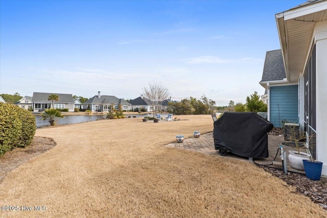 view of yard with a water view and a residential view