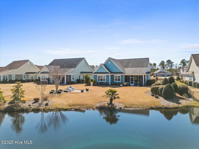 exterior space featuring a water view and a lawn