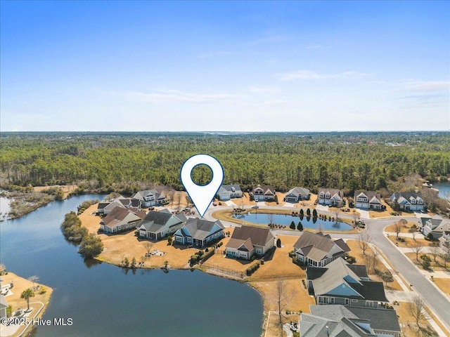 aerial view featuring a residential view, a water view, and a forest view